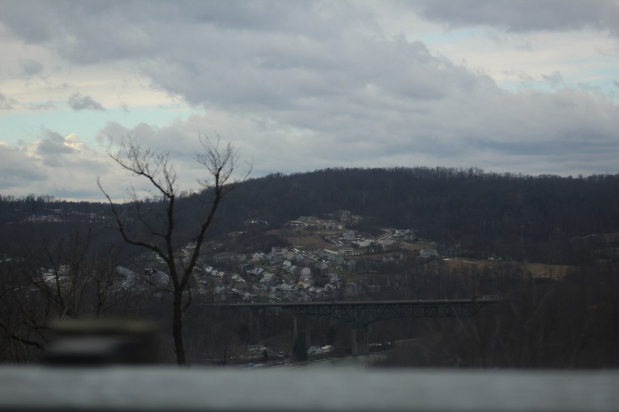 a sleepy town nestled in the hills under a lovely gray sky